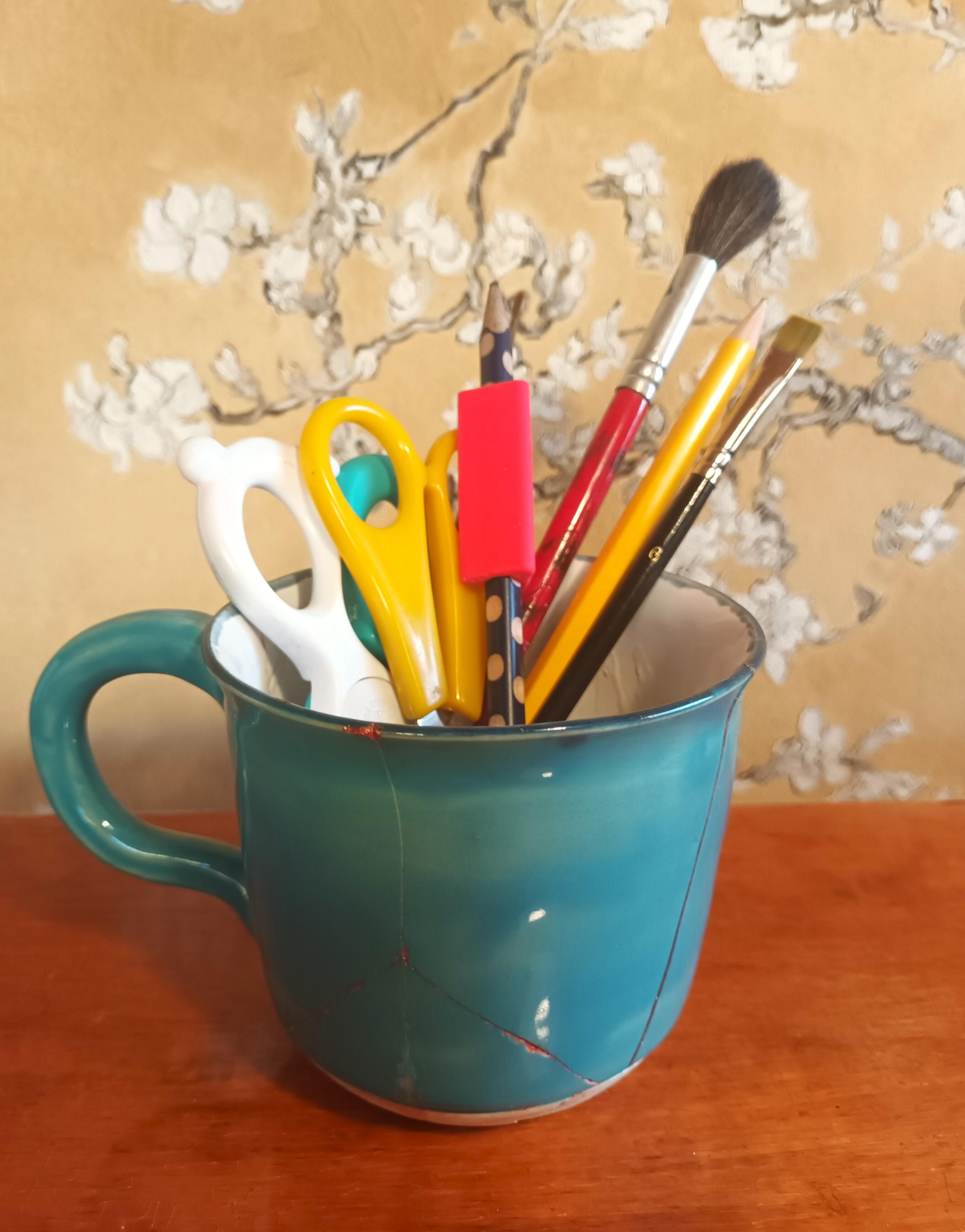 Kuvituskuva: Kyniä ja siveltimiä kupissa.